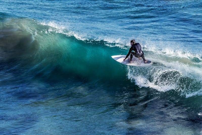 A surfer riding a clean offshore wave on Sri Lanka's south coast