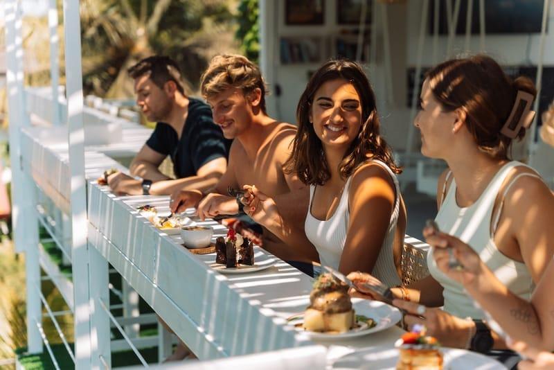 Guests sharing breakfast at the long communal table at The Surfer Beach Camp, Weligama, Sri Lanka