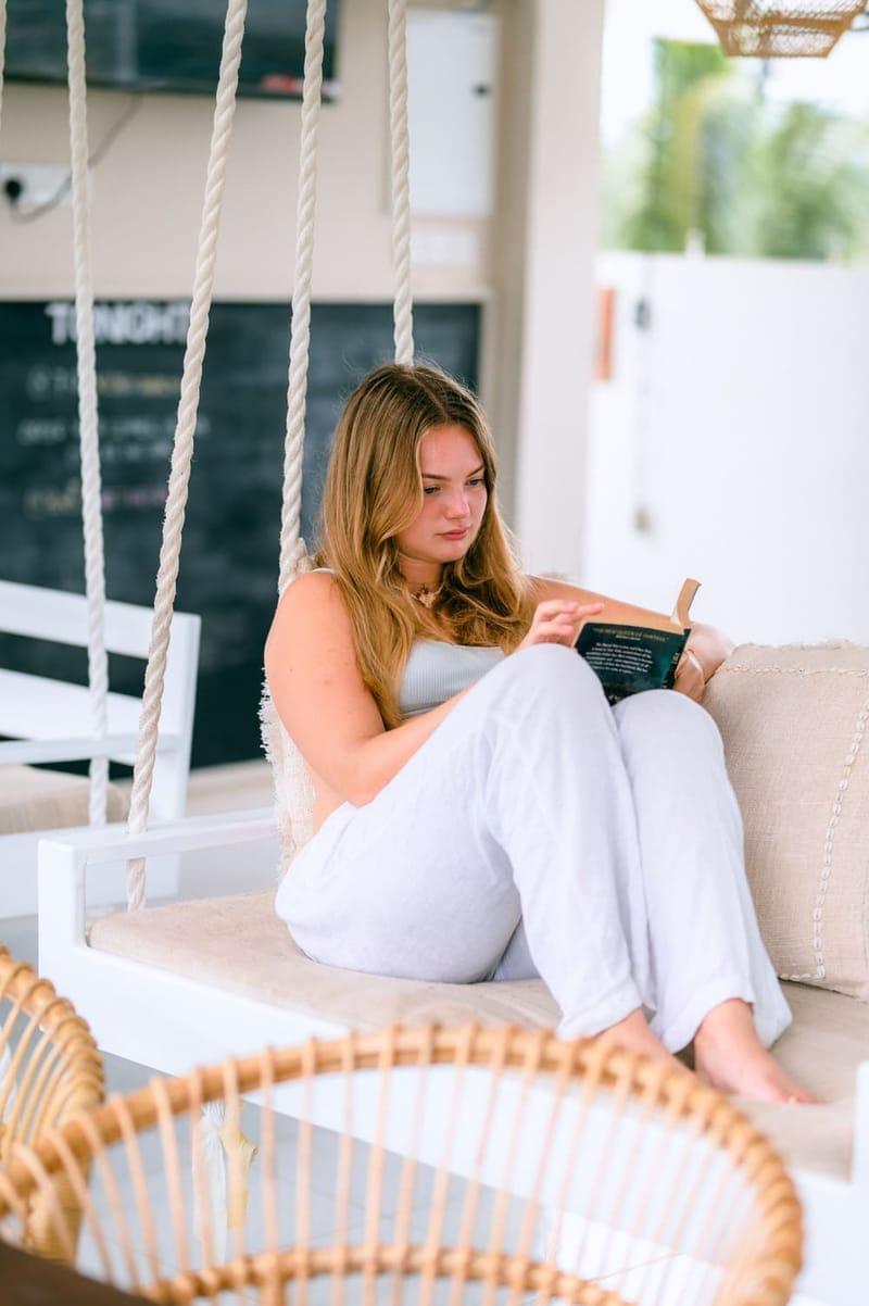 Guest reading on the rope porch swing at The Surfer camp, Weligama