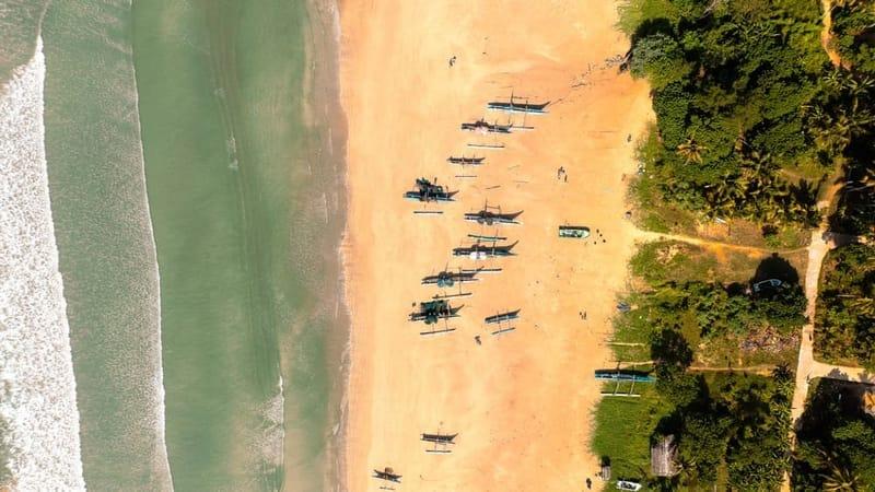 Aerial view of outrigger fishing boats on Weligama beach, Sri Lanka